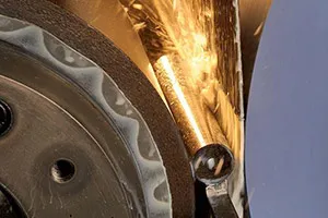 Close-up of a metal part being ground